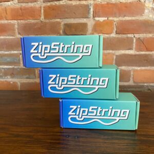 box of zipstring that is ombre blue into light green