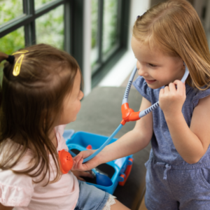 doctor set a girl checking heart rate of another girl