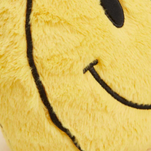 close up of yellow smiley face plush