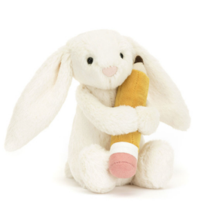 cream colored bunny plush with yellow pencil