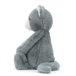 side view of grey plush kitten with white nose