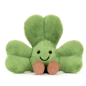 front of green plush shamrock with face and legs